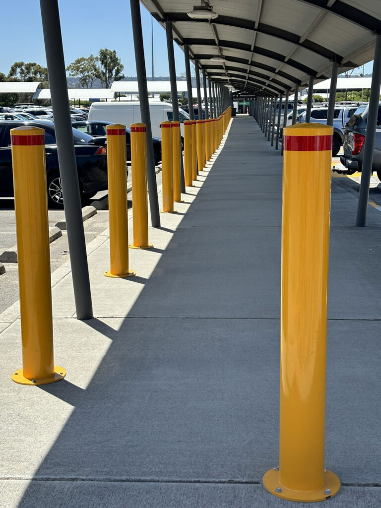 Surface mount bollards protecting pedestrian pathway in Perth car park